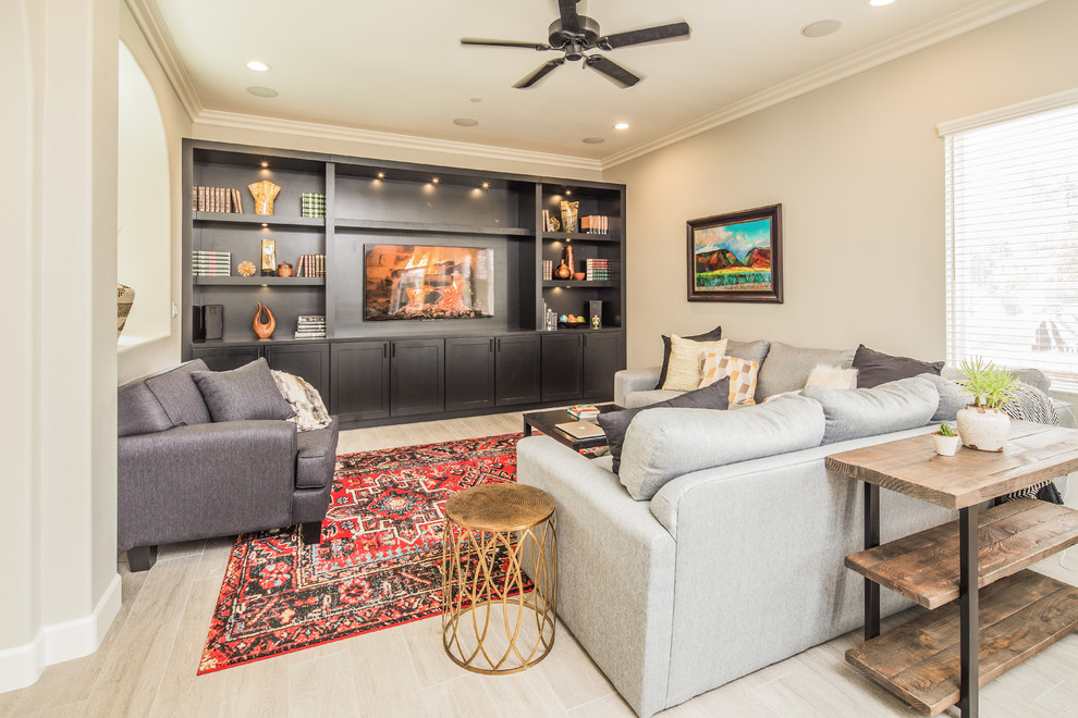 Photo of a mid-sized transitional open concept family room in San Diego with grey walls, light hardwood floors, a built-in media wall and beige floor.