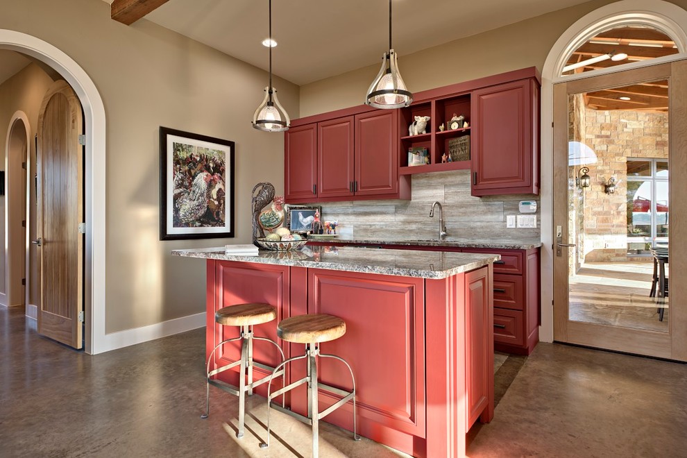 Design ideas for a country galley seated home bar in Austin with an undermount sink, raised-panel cabinets, red cabinets, marble benchtops, ceramic splashback and concrete floors.