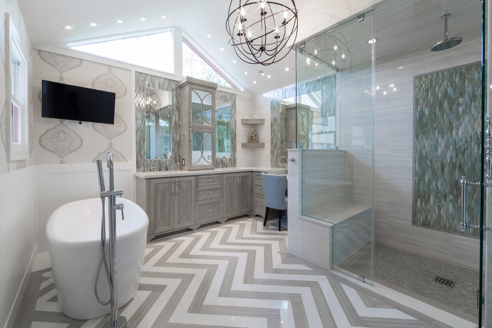Design ideas for a mid-sized transitional master bathroom in Houston with an undermount sink, grey cabinets, quartzite benchtops, a freestanding tub, a curbless shower, a two-piece toilet, gray tile, porcelain tile, grey walls, porcelain floors and recessed-panel cabinets.