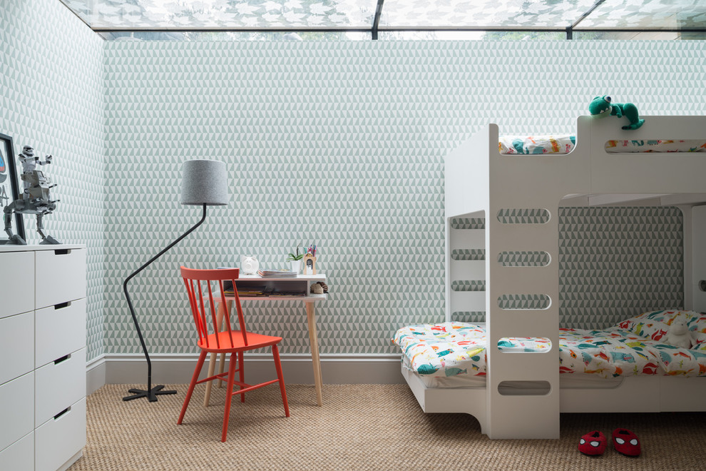 Photo of a scandinavian kids' bedroom for kids 4-10 years old and boys in London with multi-coloured walls, carpet and beige floor.