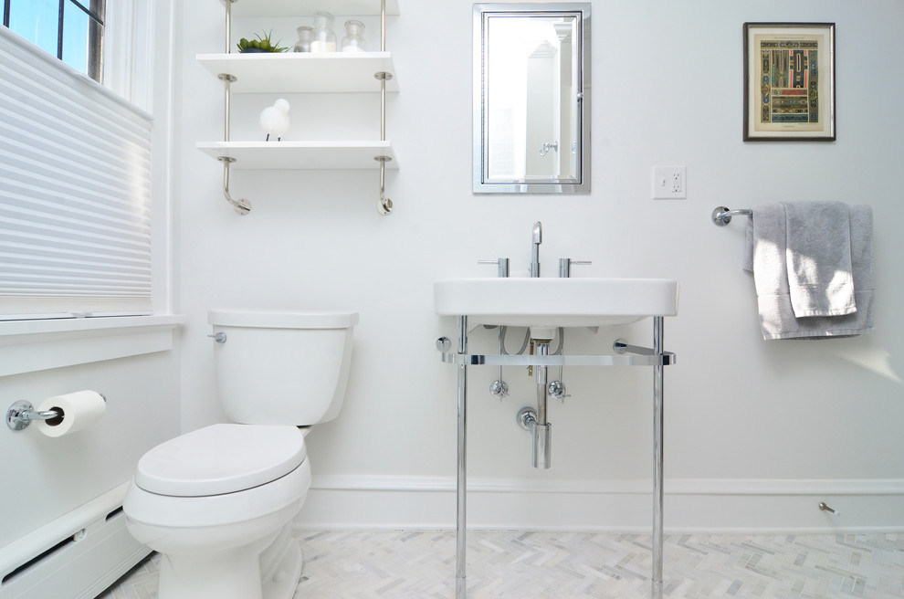 Design ideas for a small transitional bathroom in New York with open cabinets, an alcove tub, a shower/bathtub combo, a two-piece toilet, gray tile, subway tile, white walls, marble floors and a wall-mount sink.