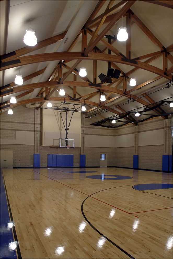 Design ideas for an expansive traditional indoor sport court in Grand Rapids with beige walls and light hardwood floors.