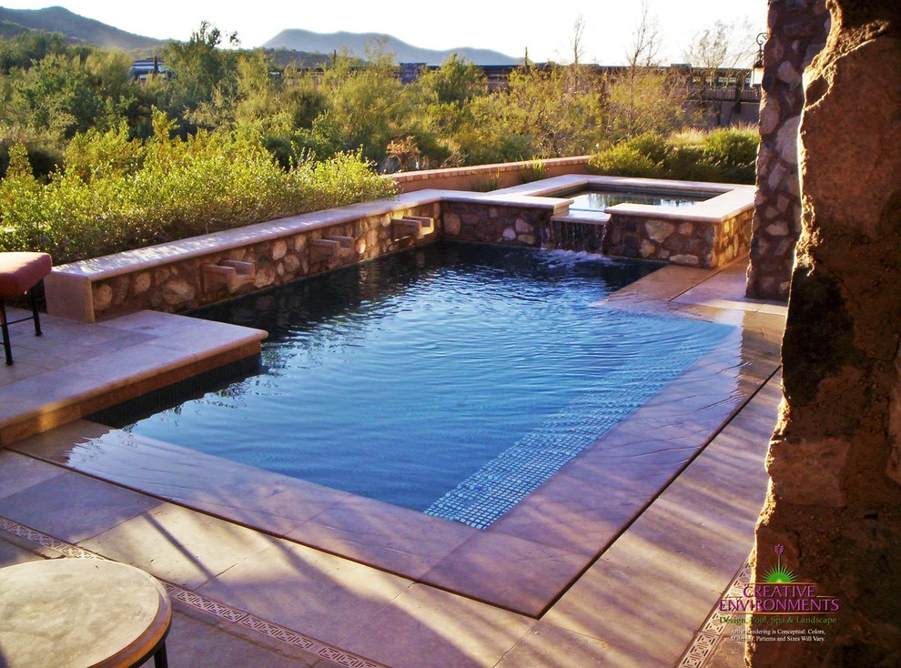 Example of a large backyard stamped concrete and custom-shaped hot tub design in Phoenix