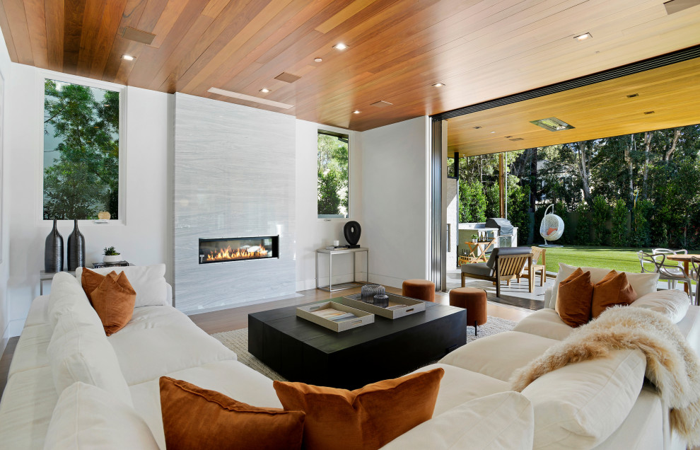 Design ideas for a contemporary formal open concept living room in Los Angeles with white walls, a ribbon fireplace, a stone fireplace surround and no tv.
