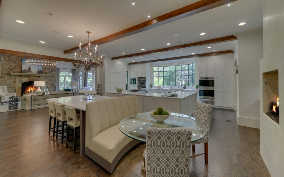 Inspiration for a large transitional u-shaped open plan kitchen in Atlanta with recessed-panel cabinets, grey cabinets, marble benchtops, marble splashback and multiple islands.