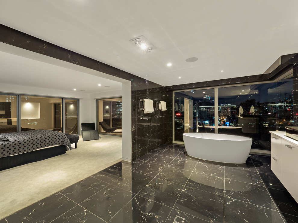 Contemporary bathroom in Brisbane with flat-panel cabinets, white cabinets, a freestanding tub, a vessel sink, white benchtops, black tile, black walls and black floor.