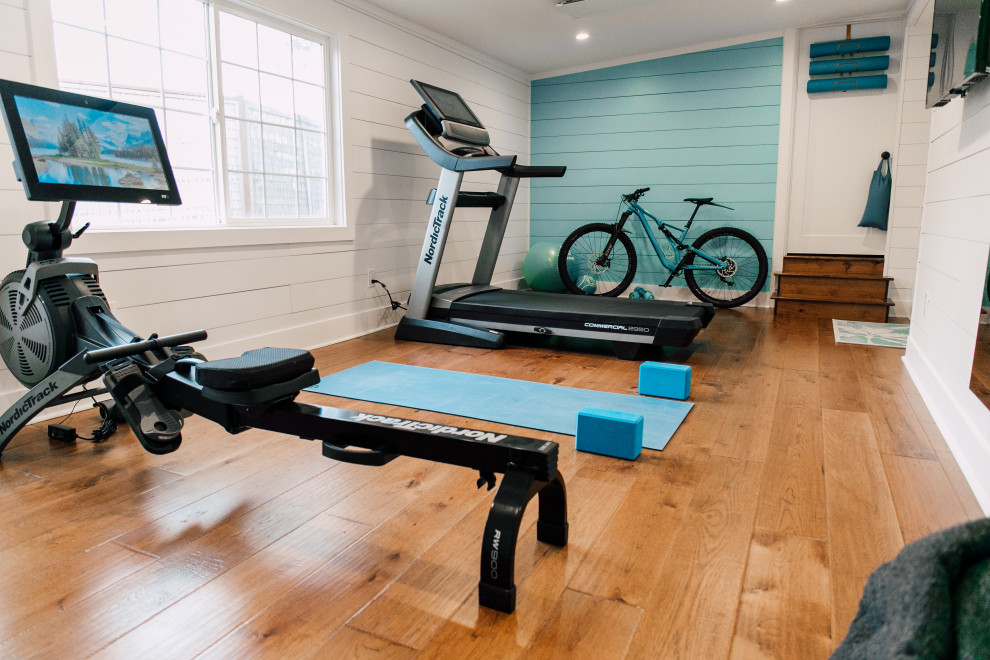 Design ideas for a medium sized eclectic multi-use home gym in Seattle with white walls, medium hardwood flooring, brown floors and a vaulted ceiling.