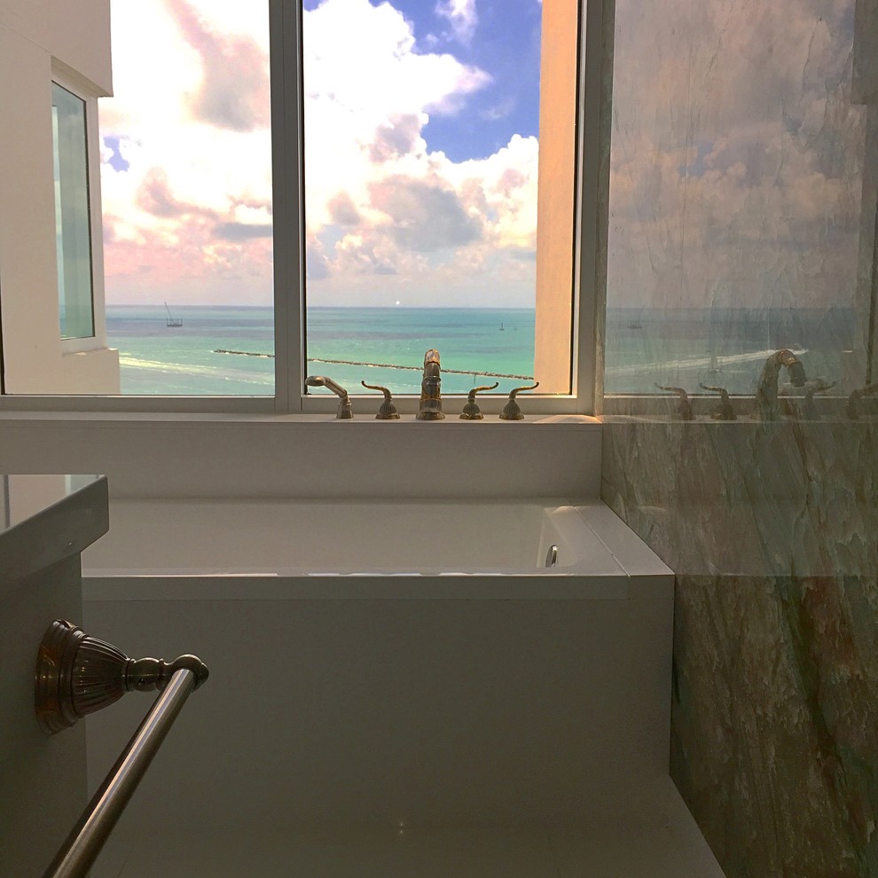 This is an example of a mid-sized contemporary kids bathroom in Miami with flat-panel cabinets, light wood cabinets, a one-piece toilet, beige tile, glass tile, beige walls and quartzite benchtops.