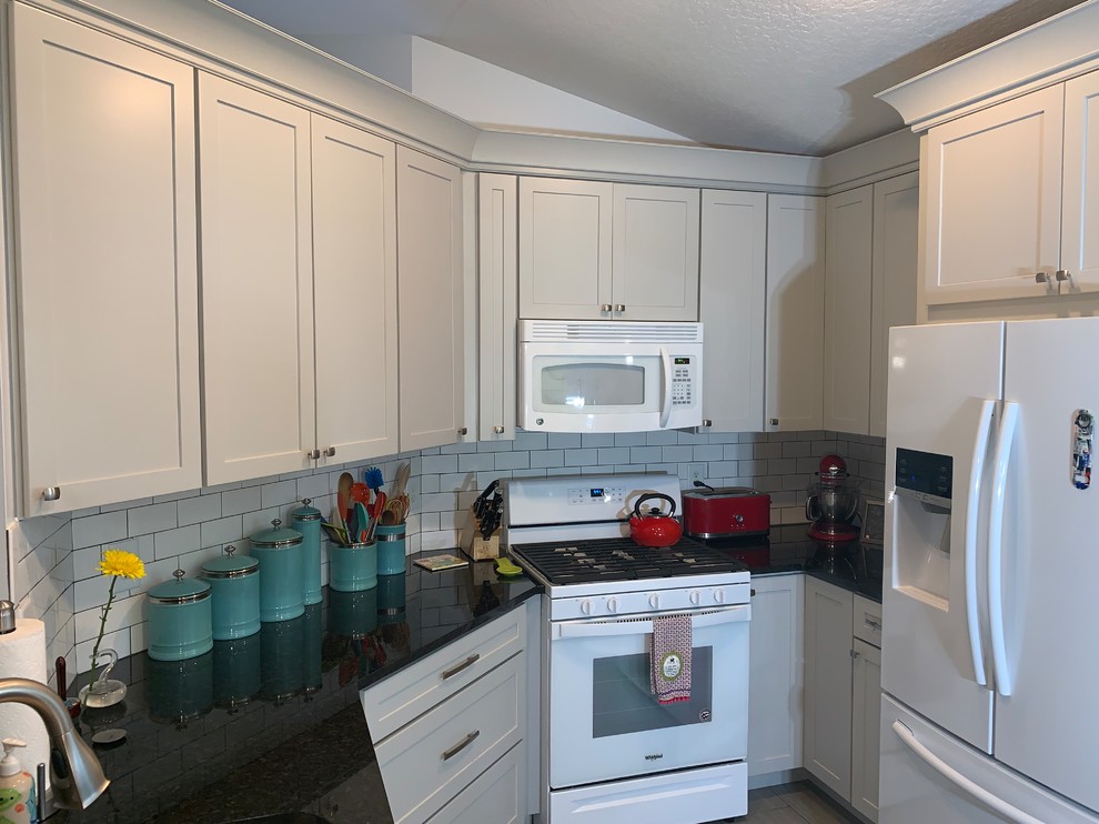 Small transitional u-shaped ceramic tile eat-in kitchen photo in Orlando with an undermount sink, shaker cabinets, gray cabinets, granite countertops, subway tile backsplash and no island