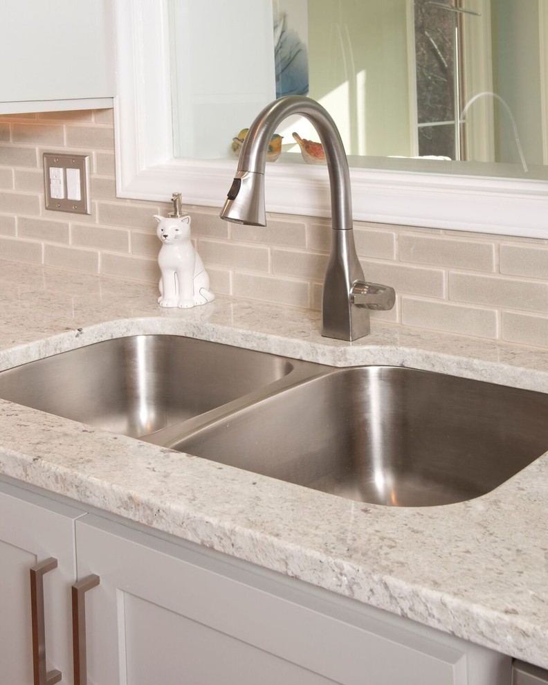 Mid-sized transitional u-shaped medium tone wood floor and brown floor eat-in kitchen photo with a double-bowl sink, gray cabinets, granite countertops, gray backsplash, subway tile backsplash, stainless steel appliances, an island and shaker cabinets