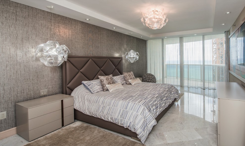 Design ideas for a mid-sized contemporary master bedroom in Miami with brown walls, marble floors and no fireplace.