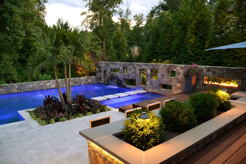 Mid-sized tropical backyard l-shaped pool in New York with tile.
