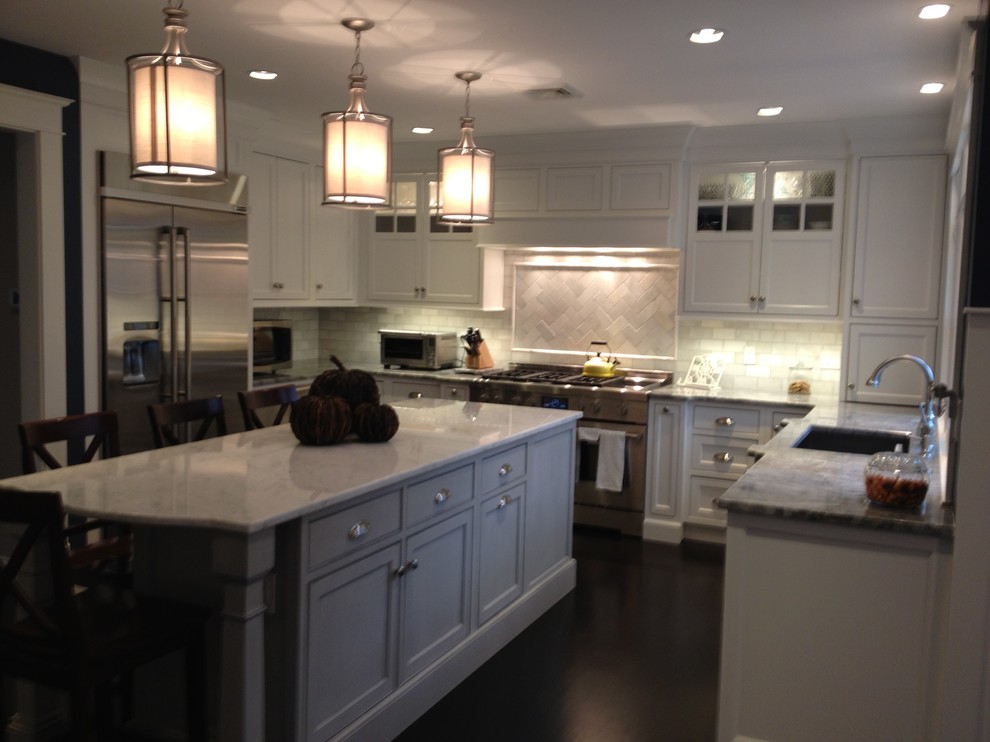 Kitchen - transitional kitchen idea in Boston with a single-bowl sink, shaker cabinets, white cabinets, granite countertops, white backsplash, stone tile backsplash and stainless steel appliances