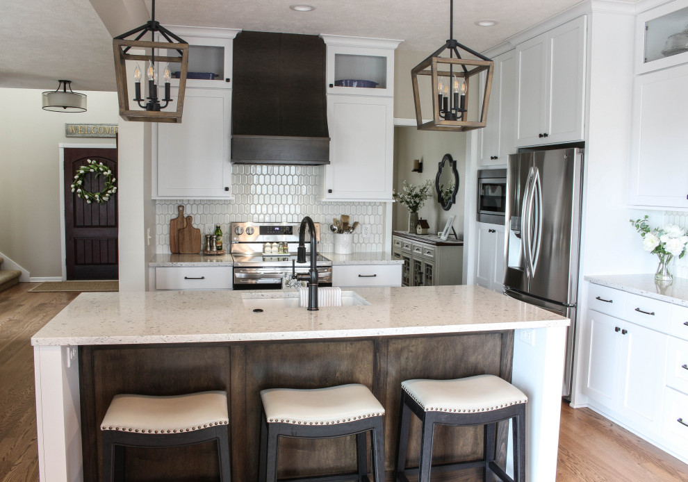 Eat-in kitchen - transitional u-shaped light wood floor eat-in kitchen idea in Other with an undermount sink, shaker cabinets, yellow cabinets, quartz countertops, white backsplash, ceramic backsplash, stainless steel appliances, an island and white countertops