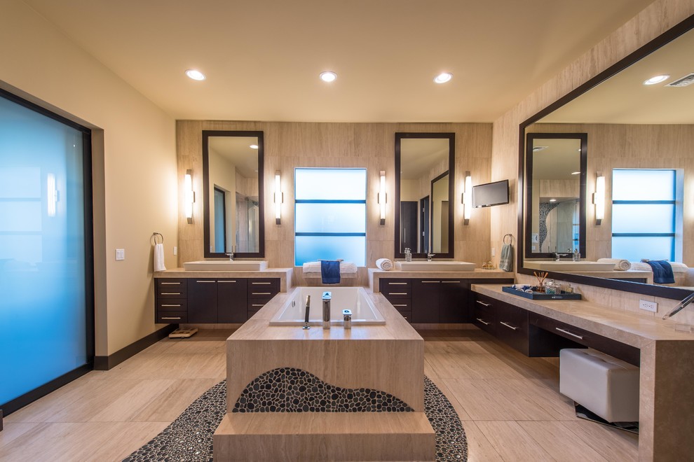 Design ideas for a transitional master bathroom in Las Vegas with flat-panel cabinets, dark wood cabinets, a drop-in tub, beige walls and a vessel sink.