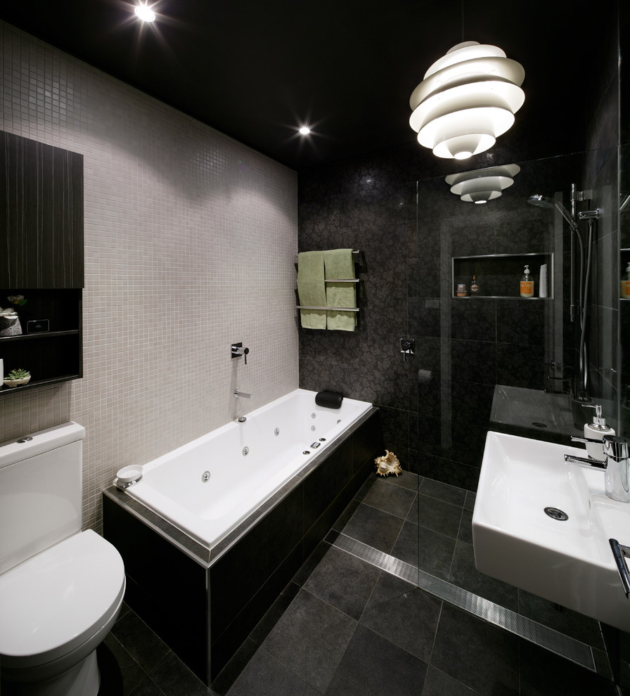 Contemporary master bathroom in Sydney with an open shower, a one-piece toilet, black tile and black walls.