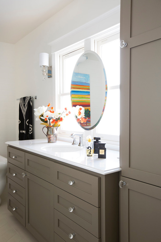 This is an example of a mid-sized eclectic master bathroom in Sacramento with grey cabinets, a freestanding tub, white tile, subway tile, white walls and ceramic floors.
