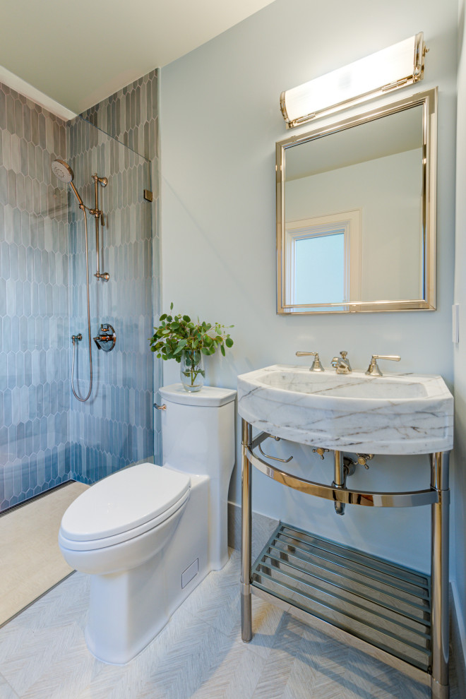 Inspiration for a transitional bathroom in San Francisco with a curbless shower, a one-piece toilet, green tile, ceramic tile, green walls, porcelain floors, a pedestal sink, marble benchtops, beige floor, a hinged shower door, grey benchtops and a single vanity.