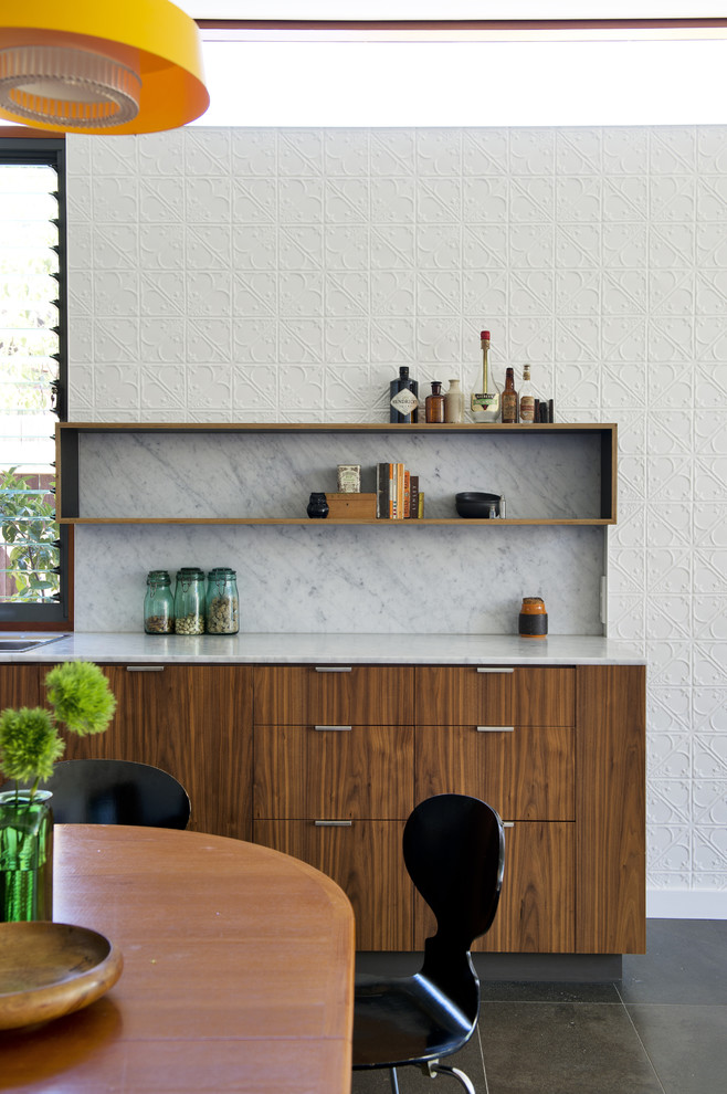 This is an example of a midcentury home bar in Perth with flat-panel cabinets and marble splashback.