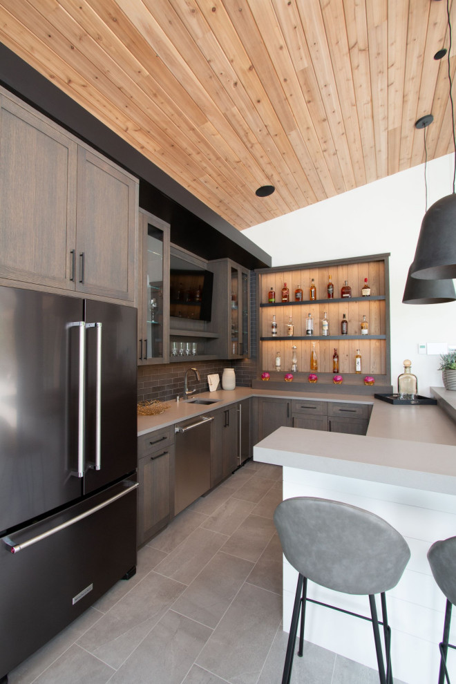 Wet bar - mid-sized modern u-shaped porcelain tile and gray floor wet bar idea in Minneapolis with an undermount sink, recessed-panel cabinets, medium tone wood cabinets, quartz countertops, black backsplash, porcelain backsplash and gray countertops