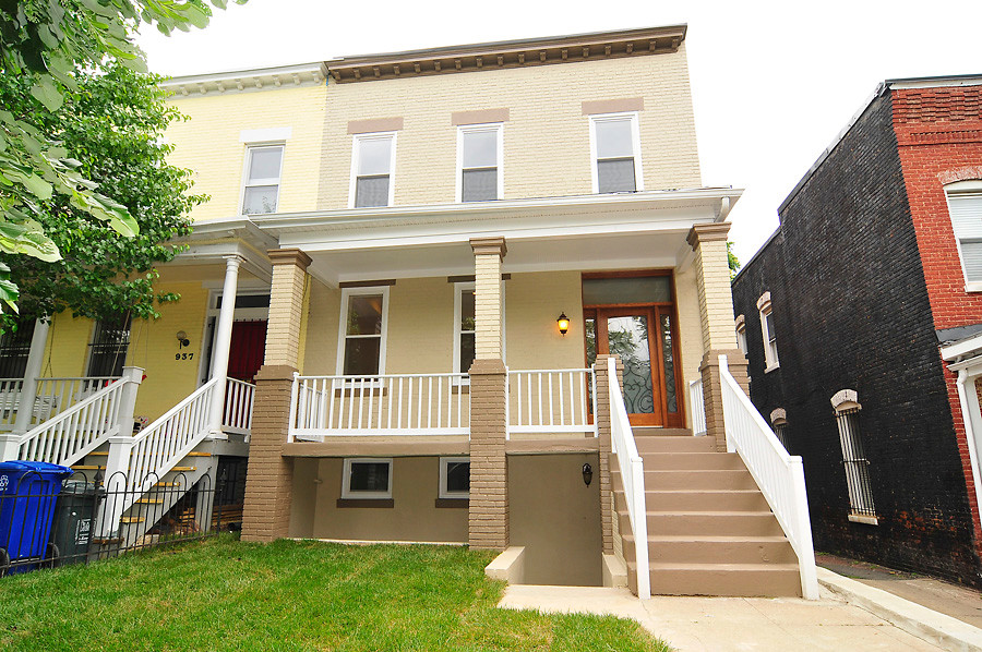 This is an example of a small traditional three-storey brick yellow exterior in DC Metro with a flat roof.