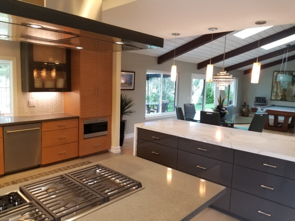 Inspiration for a transitional kitchen in Orange County with an undermount sink, flat-panel cabinets, grey cabinets, quartzite benchtops, white splashback, glass tile splashback, stainless steel appliances, vinyl floors, with island, grey floor and grey benchtop.