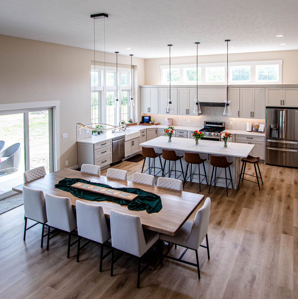 Photo of a large transitional eat-in kitchen in Cleveland with vinyl floors and brown floor.