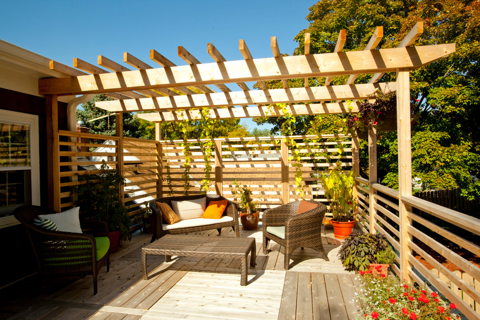 This is an example of a traditional deck in Minneapolis with a pergola.