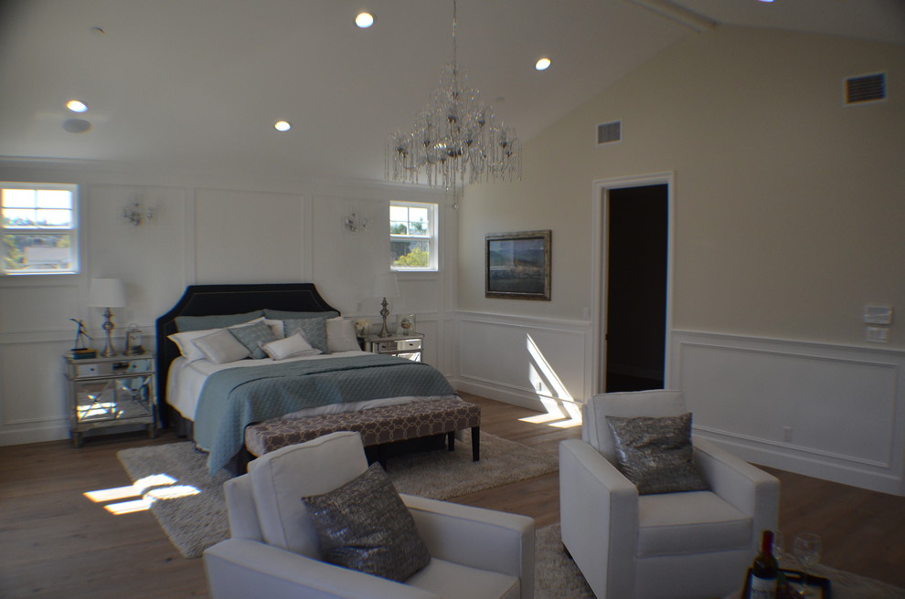 Design ideas for a mid-sized transitional master bedroom in Los Angeles with white walls, light hardwood floors, a standard fireplace, a brick fireplace surround and brown floor.