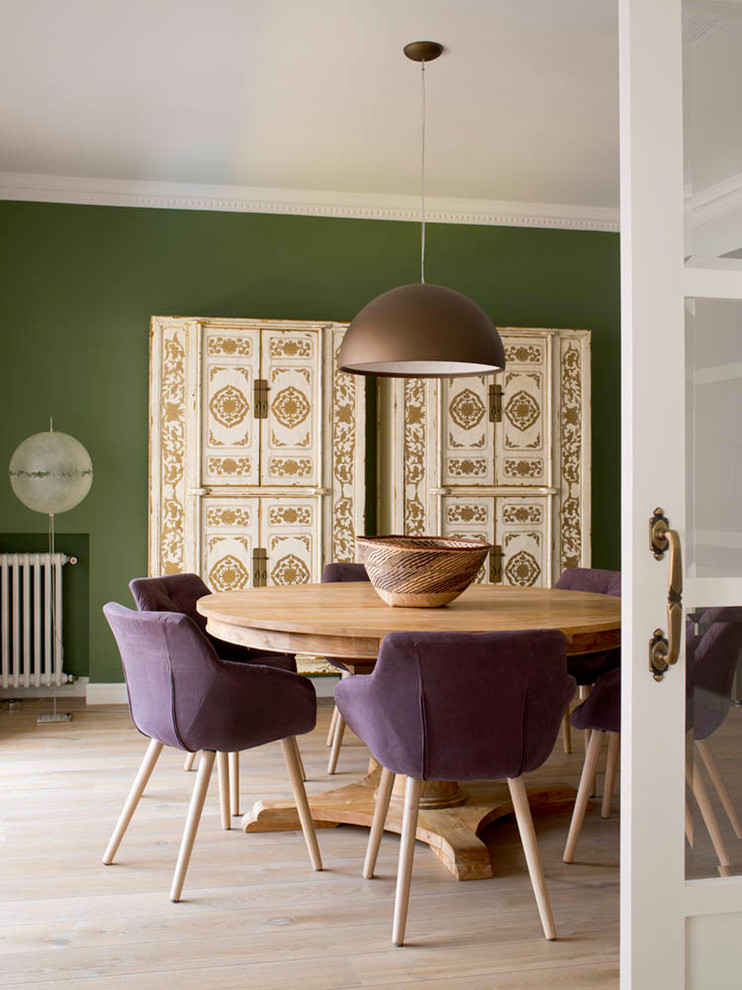 Photo of a mid-sized mediterranean separate dining room in Barcelona with green walls, light hardwood floors and no fireplace.