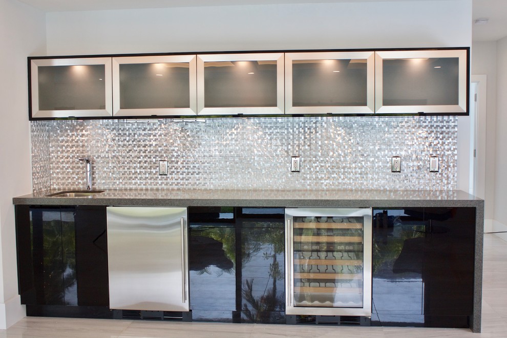 Design ideas for a contemporary single-wall wet bar in Miami with an undermount sink, flat-panel cabinets, black cabinets, quartz benchtops, grey splashback, metal splashback and marble floors.