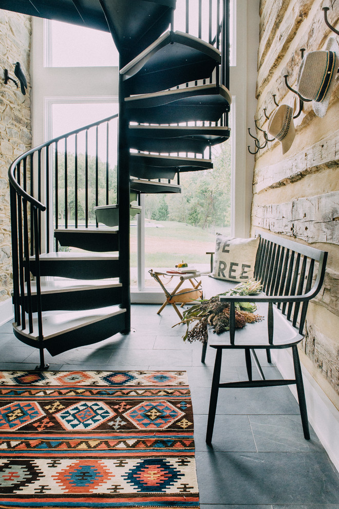 Photo of a country spiral staircase in Charleston with open risers and metal railing.