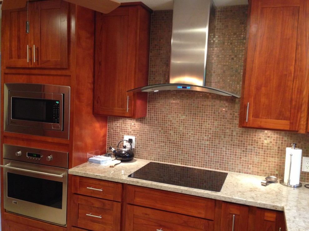 This is an example of a mid-sized traditional u-shaped separate kitchen in Hawaii with an undermount sink, shaker cabinets, dark wood cabinets, granite benchtops, multi-coloured splashback, mosaic tile splashback, stainless steel appliances, ceramic floors and with island.