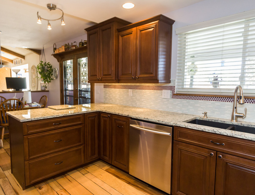 Mid-sized transitional u-shaped light wood floor eat-in kitchen photo in Denver with an undermount sink, raised-panel cabinets, medium tone wood cabinets, granite countertops, multicolored backsplash, mosaic tile backsplash, stainless steel appliances and a peninsula