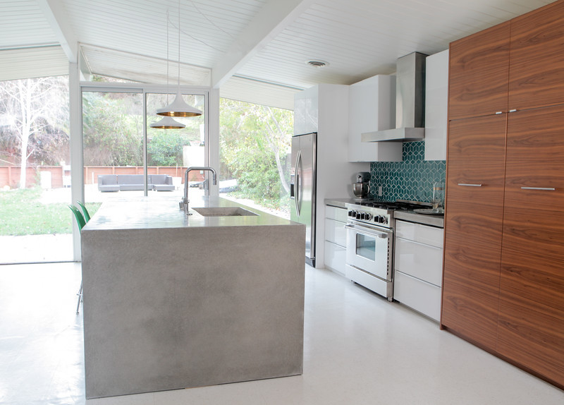 Design ideas for a mid-sized midcentury galley eat-in kitchen in San Francisco with an undermount sink, flat-panel cabinets, medium wood cabinets, concrete benchtops, blue splashback, ceramic splashback, stainless steel appliances, linoleum floors and with island.