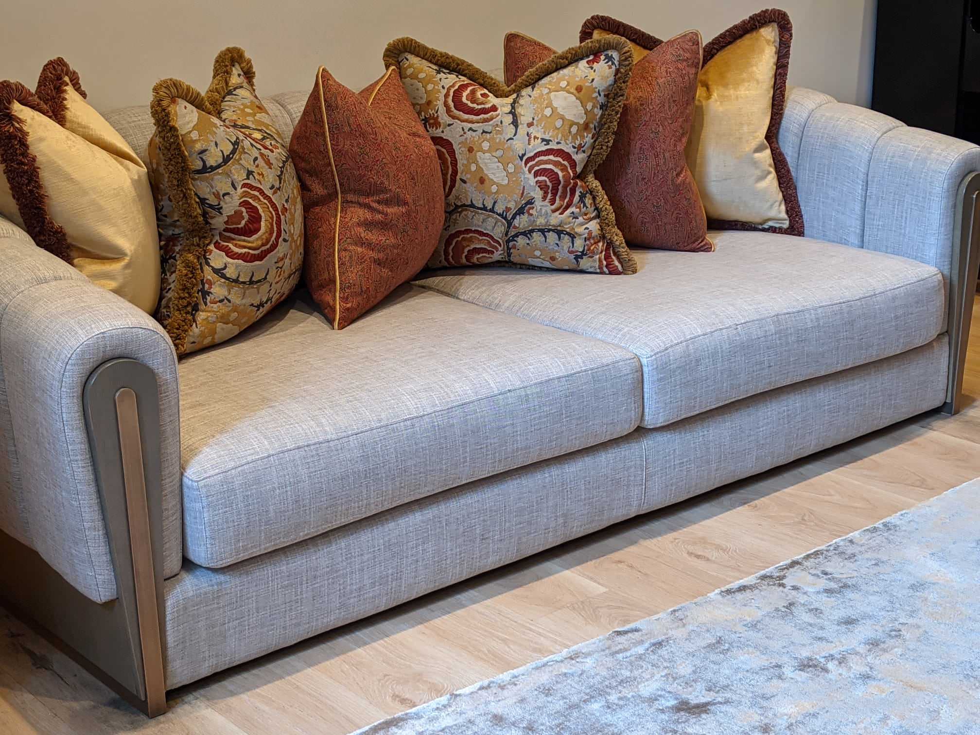 Bespoke Sofa with fluted back & arms and oak & antique brass armrests