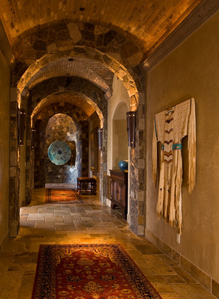 Hallway - rustic travertine floor hallway idea in Phoenix with beige walls