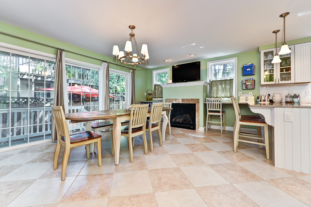 Traditional kitchen/dining combo in DC Metro with green walls and a standard fireplace.