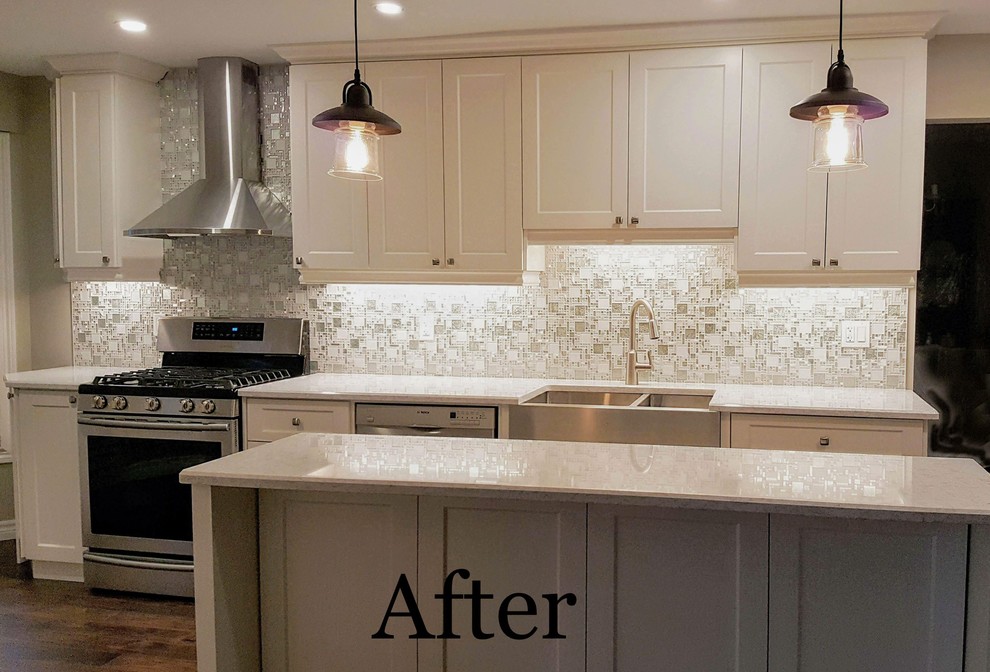 Inspiration for a large transitional galley laminate floor and brown floor eat-in kitchen remodel in Toronto with a farmhouse sink, recessed-panel cabinets, white cabinets, quartzite countertops, gray backsplash, mosaic tile backsplash, an island and white countertops