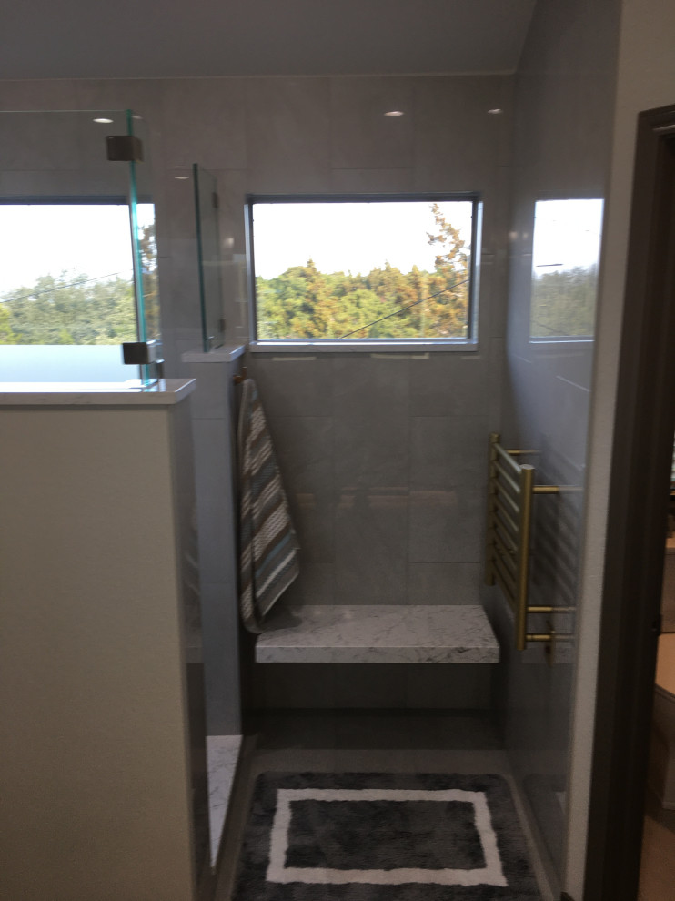 Bathroom - mid-sized transitional master gray tile porcelain tile, gray floor and double-sink bathroom idea in Austin with raised-panel cabinets, gray cabinets, a two-piece toilet, an undermount sink, quartz countertops, beige countertops and a built-in vanity