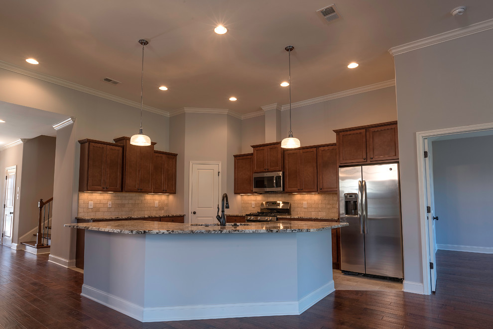 Inspiration for a mid-sized transitional l-shaped medium tone wood floor open concept kitchen remodel with an undermount sink, shaker cabinets, medium tone wood cabinets, granite countertops, beige backsplash, stone tile backsplash, stainless steel appliances and an island