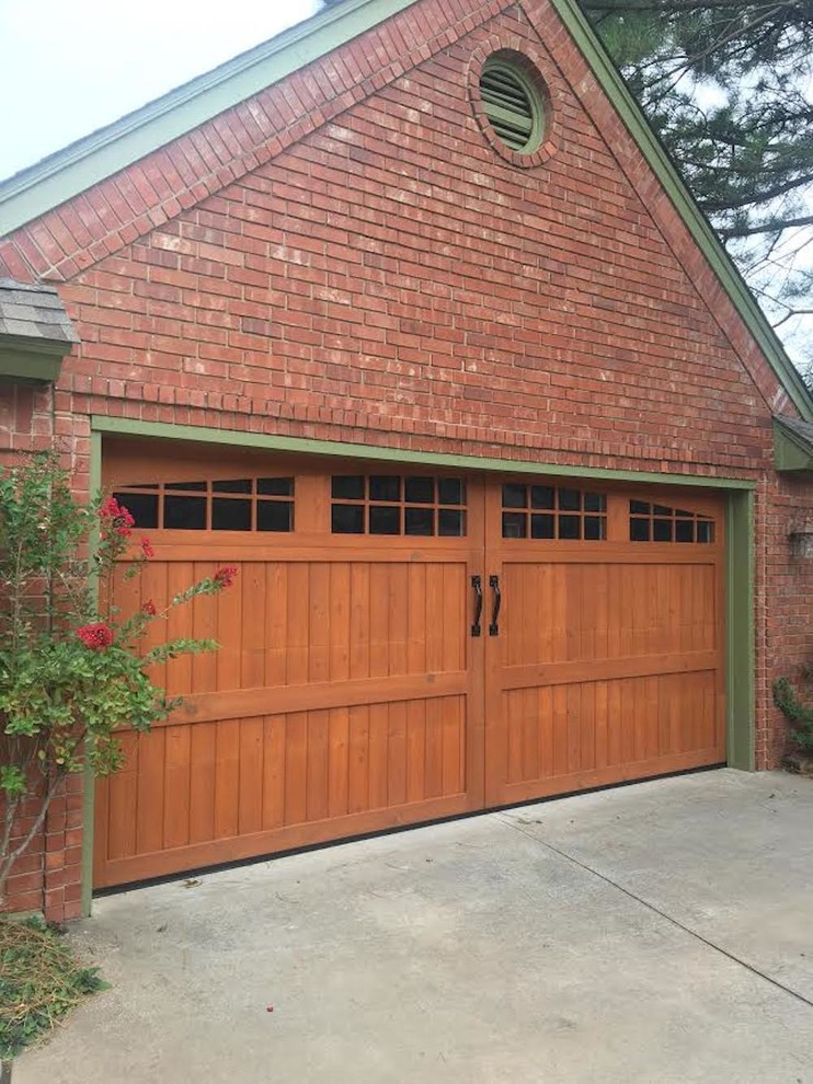This is an example of a mid-sized arts and crafts attached two-car garage in Oklahoma City.
