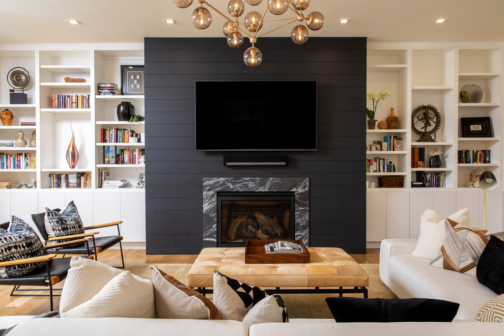 Design ideas for a country family room in Other with white walls, a wood fireplace surround and a wall-mounted tv.