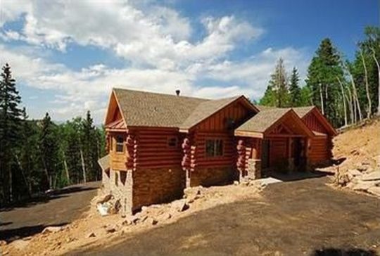 Example of a mid-sized mountain style red two-story wood exterior home design