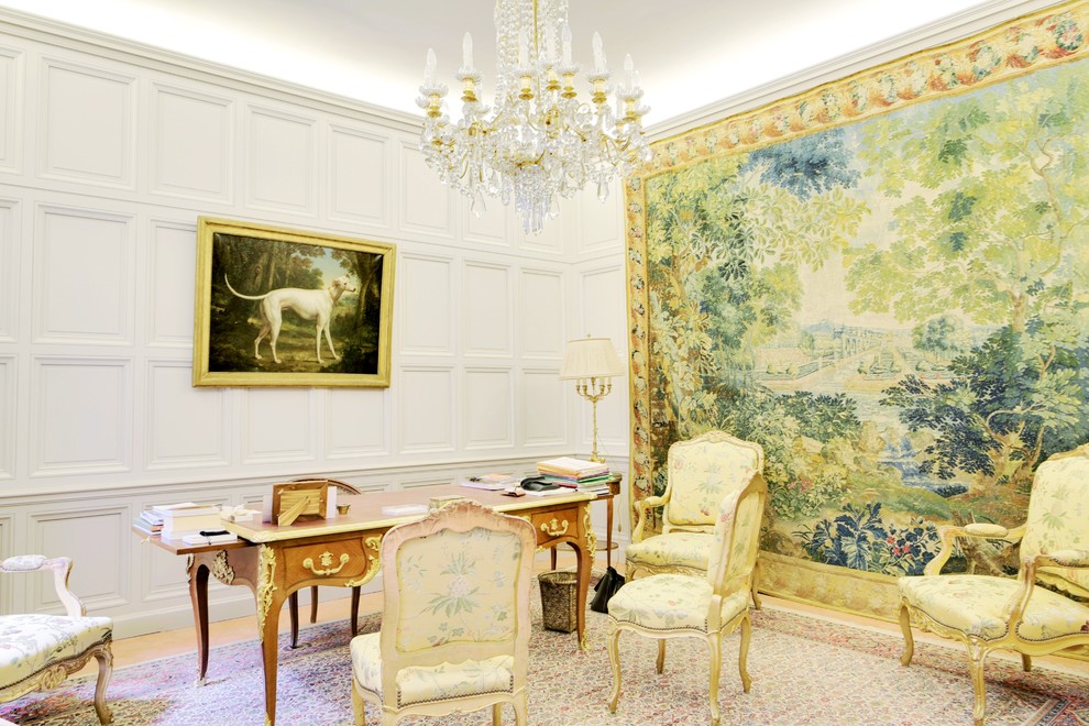 This is an example of a large traditional study room in Marseille with white walls, light hardwood floors, a freestanding desk and beige floor.