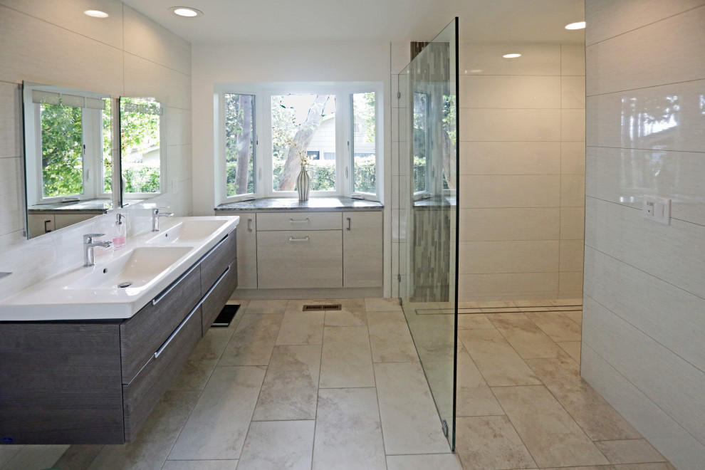 Inspiration for a huge transitional master beige tile and porcelain tile porcelain tile, beige floor and double-sink doorless shower remodel with flat-panel cabinets, medium tone wood cabinets, a two-piece toilet, beige walls, an integrated sink, quartz countertops, white countertops and a floating vanity