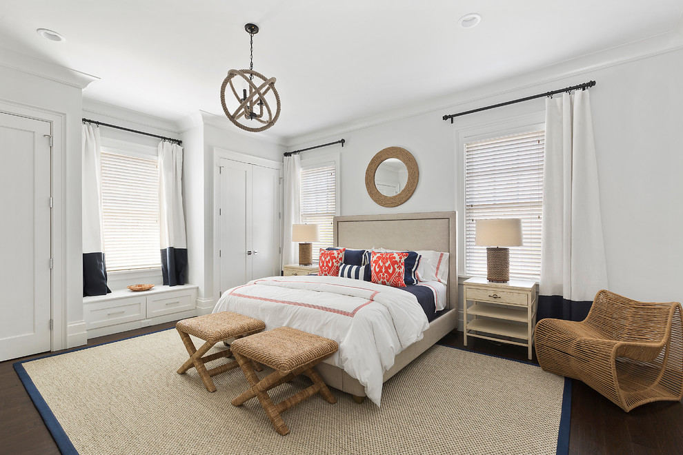 Design ideas for a mid-sized beach style guest bedroom in New York with white walls, medium hardwood floors and brown floor.