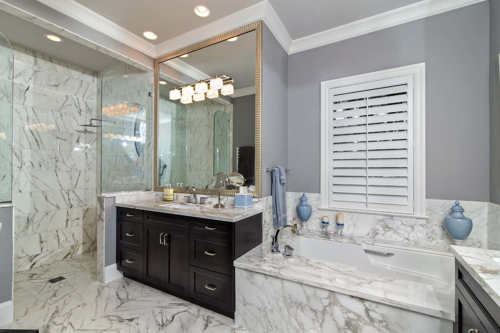 Inspiration for a large transitional master bathroom in Miami with recessed-panel cabinets, dark wood cabinets, an undermount tub, an open shower, white tile, stone tile, purple walls, marble floors, an undermount sink and quartzite benchtops.