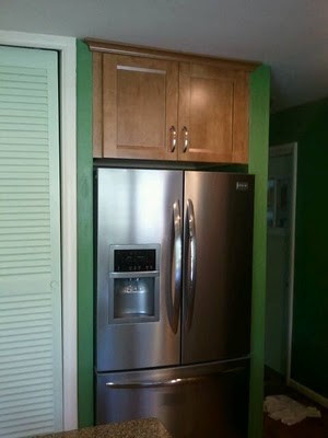 Inspiration for a mid-sized transitional u-shaped medium tone wood floor eat-in kitchen remodel in Cincinnati with an undermount sink, flat-panel cabinets, medium tone wood cabinets, quartz countertops, multicolored backsplash, mosaic tile backsplash, stainless steel appliances and an island