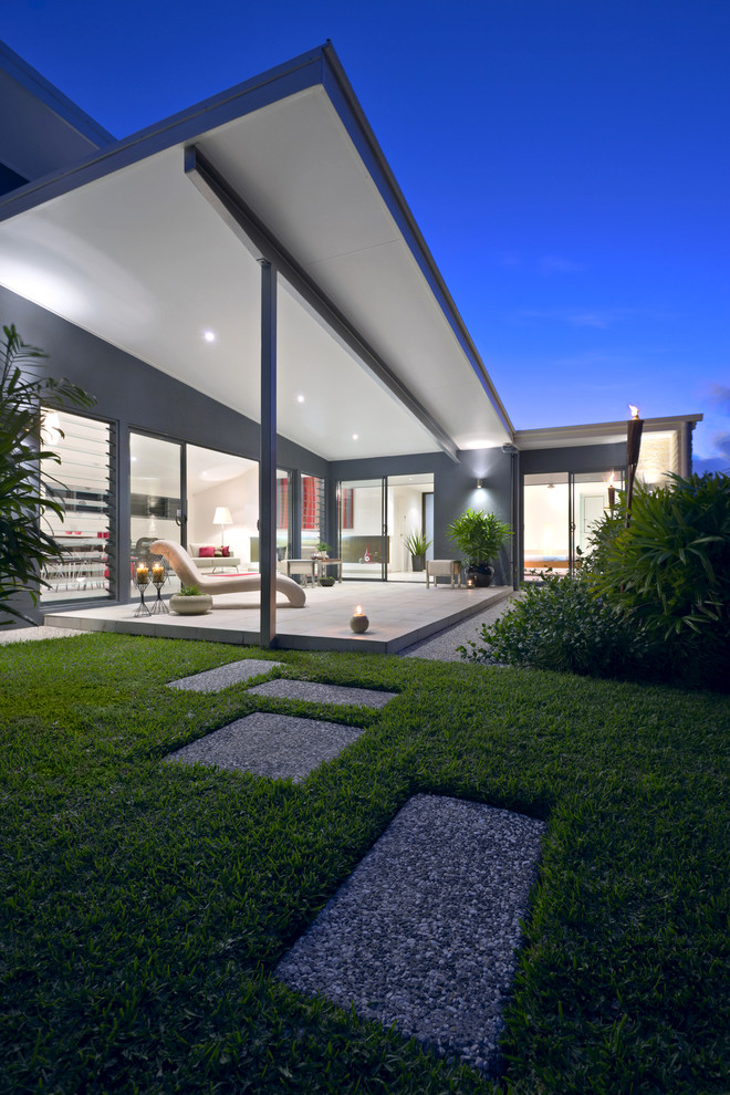 Inspiration for a large contemporary side yard deck in Sunshine Coast with a roof extension.